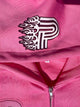 Cose-up of Primoir flaming P logo embroidered on pink hoodie hood