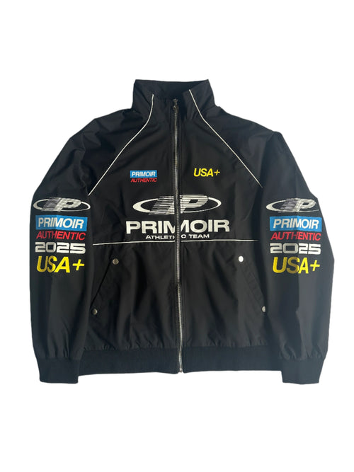 Front view of black Primoir USA+ jacket with bold sleeve and chest branding, laid flat on a white background